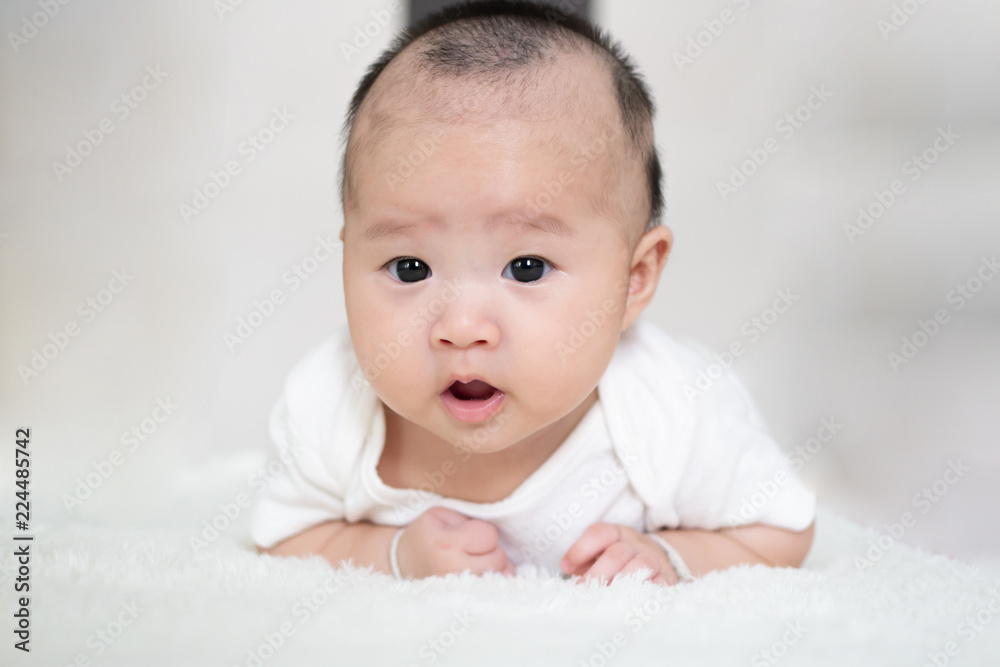 Asian Adorable baby girl, Newborn smilling ,concept of Nursery for young children, Infant nappy change skin care. Cute kid playing on the bed. Asian Adorable baby girl, Newborn smilling ,concept of Nursery for young children, Infant nappy change skin care. Cute kid playing on the bed.