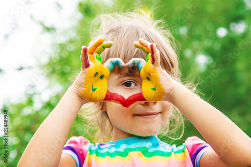 Fotografie children hands in colors. Summer photo. Selective focus.