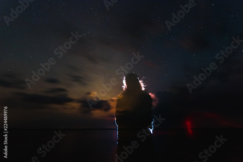 A lighting bolt striking from bright clouds in the night. Belarus. The starry sky.