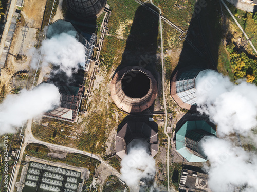 Concept of environmental pollution, aerial drone view of smokestack pipe steel plant, industrial panoramic landscape with autumn vegetation,mair emissions from the manufacturing sector, top down view photo