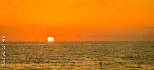 There is nothing quite so captive as watching the sun go down while strolling along the beach. Everybody seems to stop what they are doing to take in the beautiful colors of the sky and ocean waters