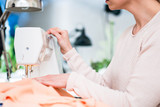 Close-up of a woman using electric sewing machine