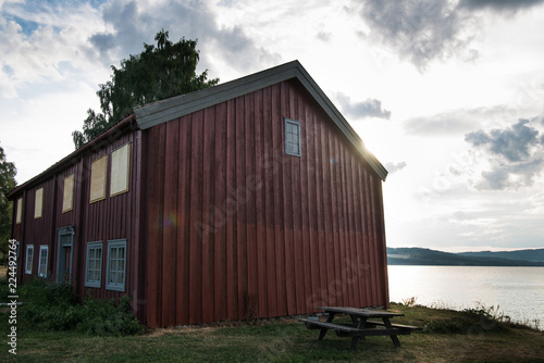 scenic view of red building near lake, Hamar, Hedmark, Norway
