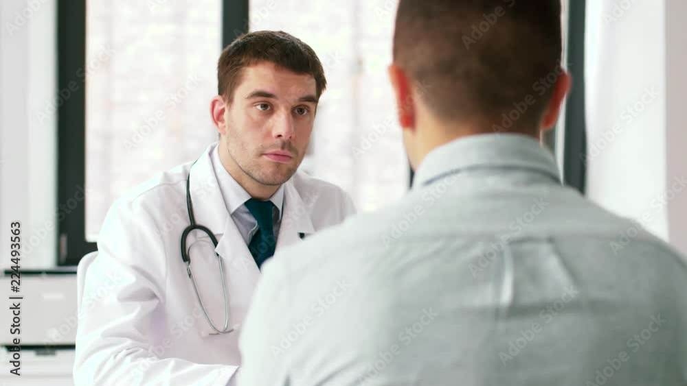 medicine, healthcare and people concept - doctor and male patient having health problem meeting at hospital medicine, healthcare and people concept - doctor and male patient having health problem meeting at hospital