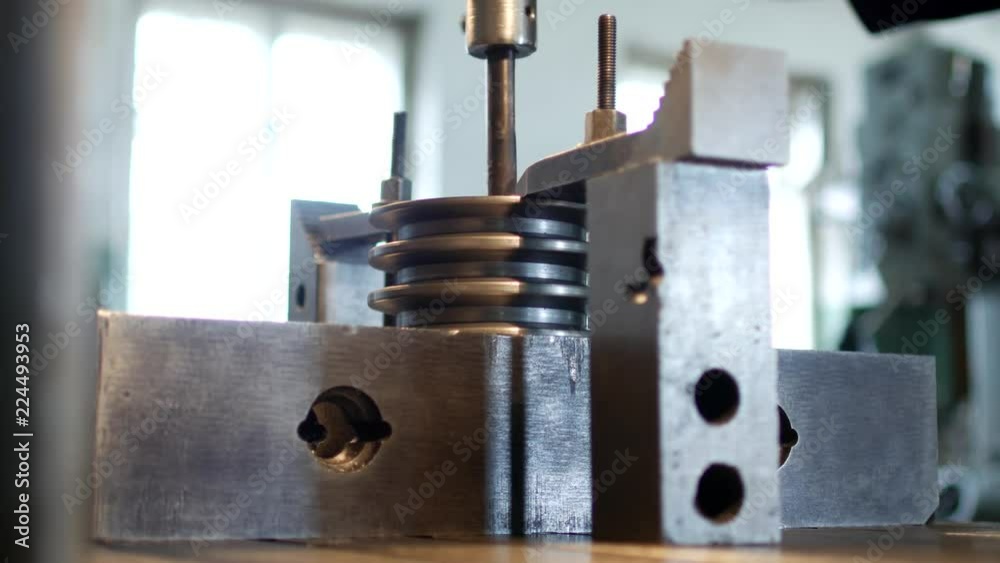 Drilling a hole with a drilling machine in a metal workpiece pulley, close-up, industry, manufacturing pulley, close-up Drilling a hole with a drilling machine in a metal workpiece pulley, close-up, industry, manufacturing pulley, close-up