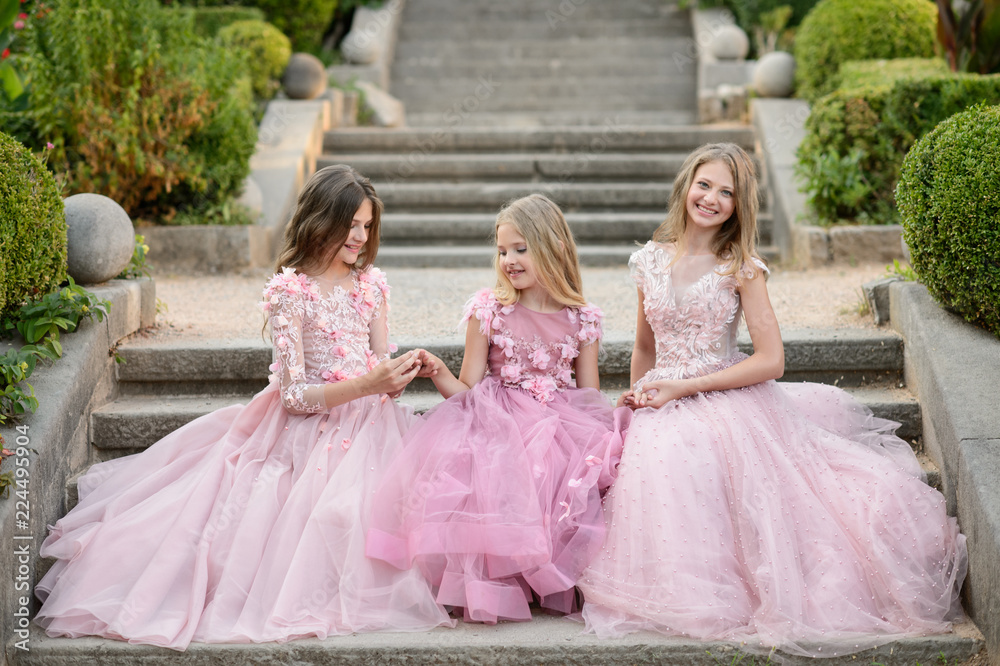 Beautiful girls in amazing dress outdoor. Children bridesmaids