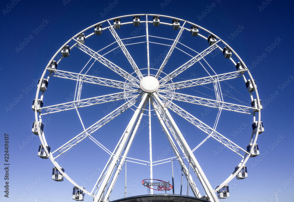 white Ferris wheel with blue background
