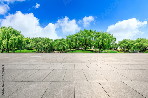 Empty city square floor and green woods scenery