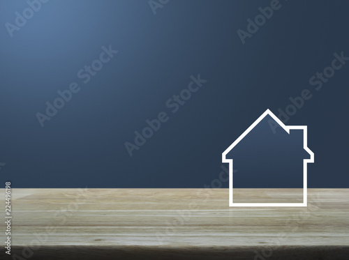 House icon with copy space on wooden table over light blue gradient background, Business real estate concept
