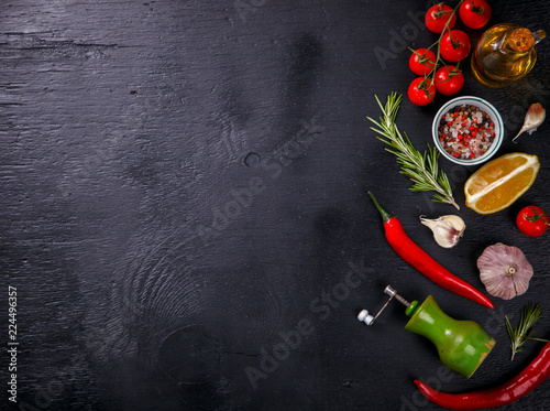  Ingredients for Cooking Vegetables,Tomatoes,Peppers,Garlic,Rosemary on a on Black Background, top view. Concept of Healthy Food.Copy space for Text. selective focus.