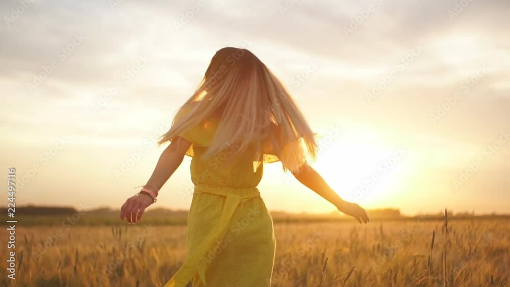Young beautiful girl in red dress in the field at sunset. Slow motion. HD Young beautiful girl in red dress in the field at sunset. Slow motion. HD