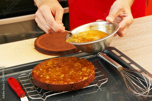 Marmalade layering on a cake to make icing of traditional cake
