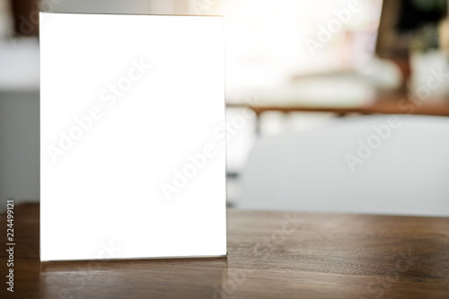 Mock up blank menu frame on table in coffee shop stand for your text of display your product photo