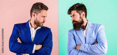 Business partners competitors in suits with tense bearded faces. Businessmen stylish appearance jacket pink blue background. Tense face expression competitors. Business competition and confrontation