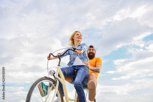 Couple with bicycle romantic date sky background. Let her be leader. Psychology of relationships. Leadership in family and marriage. Girl controls bicycle handlebar. Couple in love date cycling