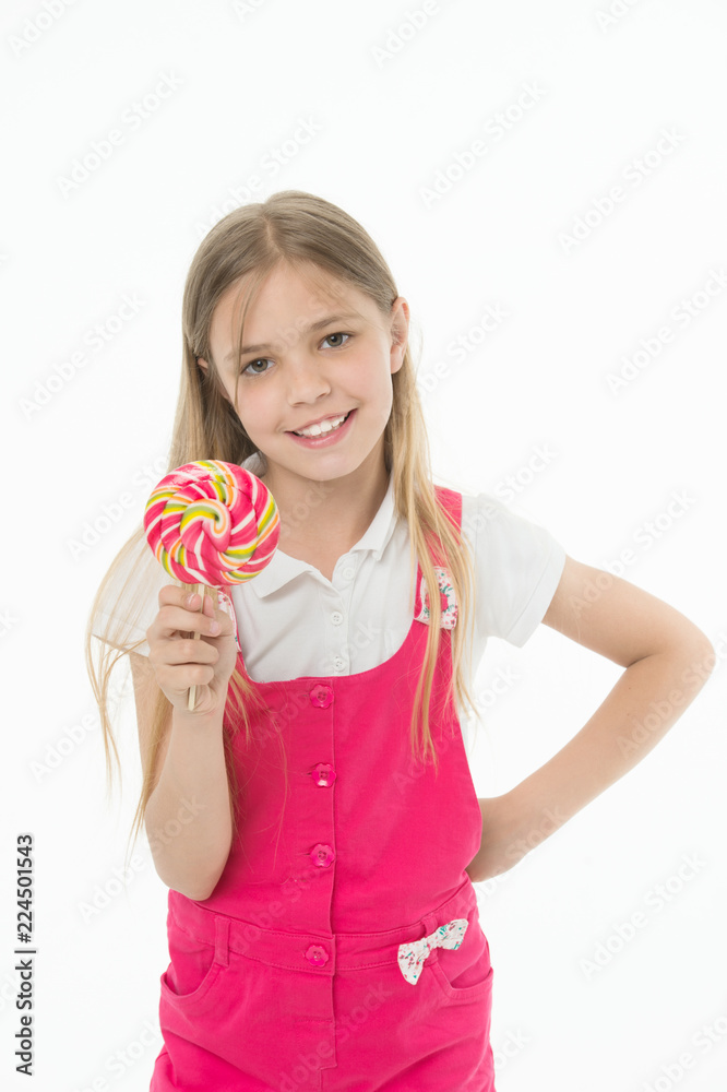 Little girl with lollipop. Little girl hold lollipop candy on stick. Happy childhood years. She has a sweet tooth. Food that reminds you of your childhood Little girl with lollipop. Little girl hold lollipop candy on stick. Happy childhood years. She has a sweet tooth. Food that reminds you of your childhood
