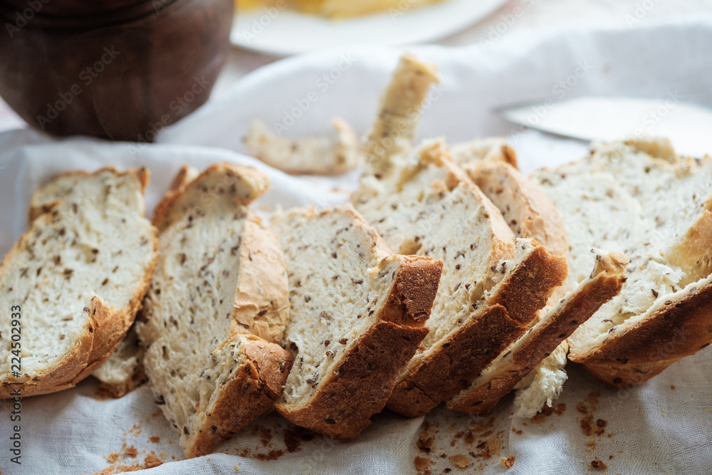 Breakfast in country house. Homemade baked bread, pitcher withmilk on table.