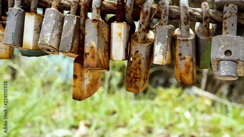A lot of old and rusty love padlocks hanging on the bridge to represent forever love