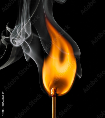 Ignition of a match, with smoke on dark background