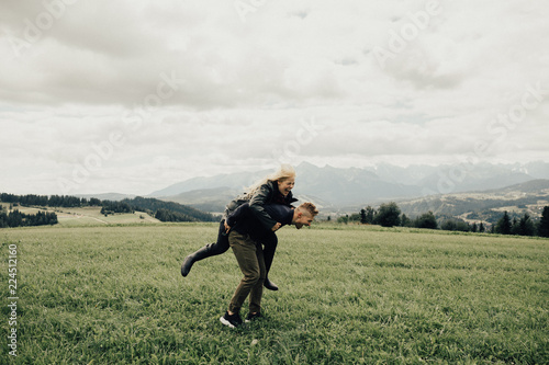 Happy young couple having fun in mountains. Travel happy emotions Lifestyle concept. Young family traveling active  vacations © Helga Bragina