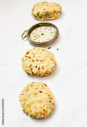 vintage clock gluten freee salt cookies with sesame  sunflower and flax seeds on white background