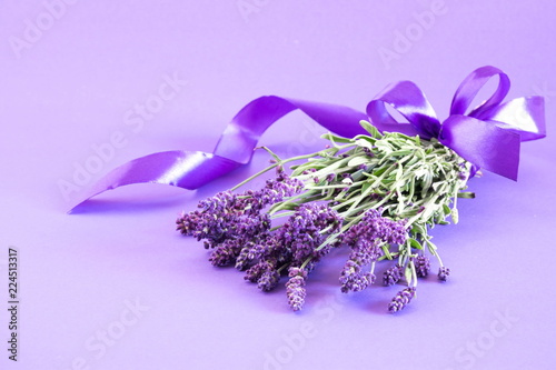 Lavender. Bunch fresh of lavender on purple table background. Violet flowers. Greeting floral card with place for text. 