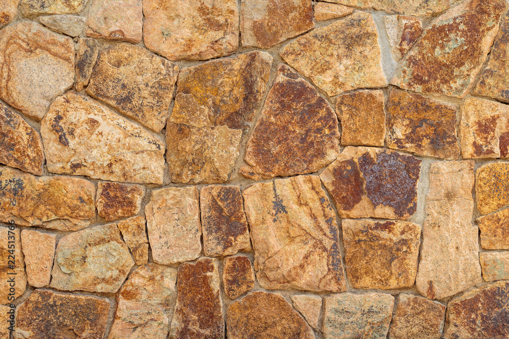 Old beige stone wall background texture close up Old beige stone wall background texture close up