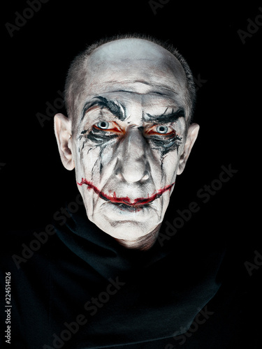 Bloody Halloween theme: The crazy maniak face on dark studio background