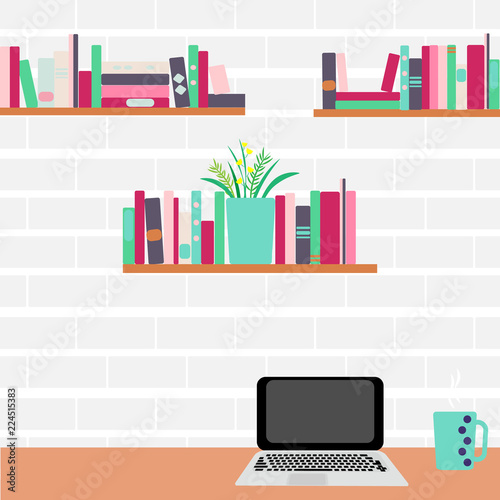 Workplace. Computer and bookshelves on a brick wall