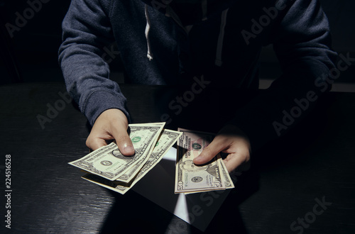 Businessman giving bribe banknote money corruption scam in dark. concept bribery for business.