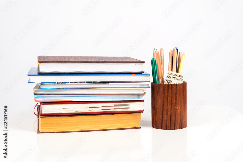 Premium Photo  School supplies on a desk stack of books notebook and many  pencils laying on the table