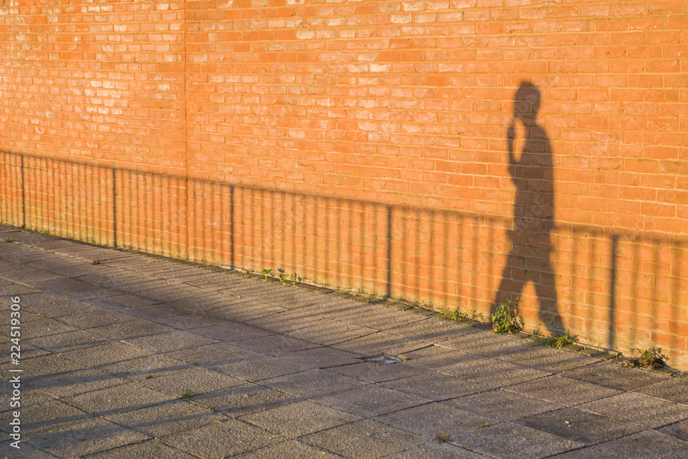 shadow of a man walking on the street