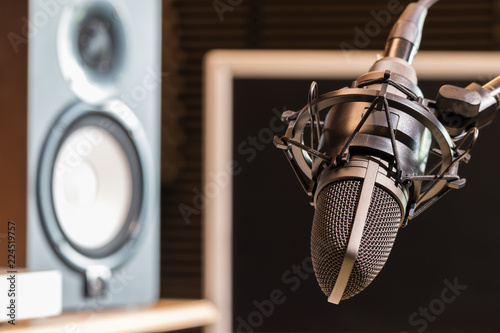studio condenser microphone and loudspeakers monitor. recording concept. music background
