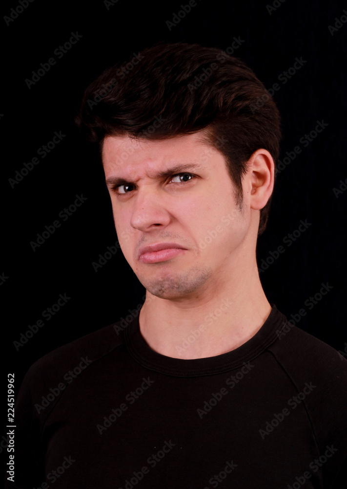 Obraz premium Frustrated unhappy man. Portrait black background