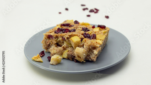 Piece of Apple Crumble with Cranberries on the Grey Table on a White Background.