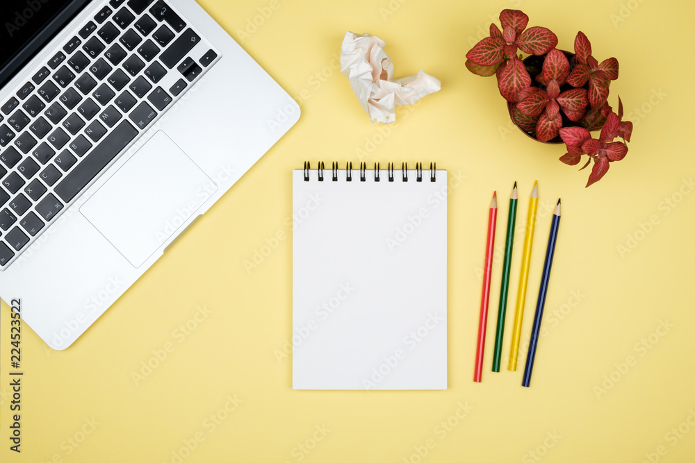 Minimal workplace with laptop and blank notepad Minimal workplace with laptop and blank notepad