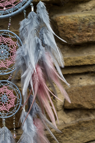 Fototapeta Naklejka Na Ścianę i Meble -  Handmade dream catcher with feathers threads and beads rope hanging