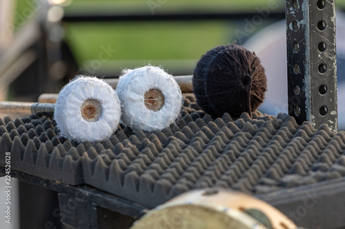 Obraz na plátne three large mallets waiting to be used by a sideline percussionist