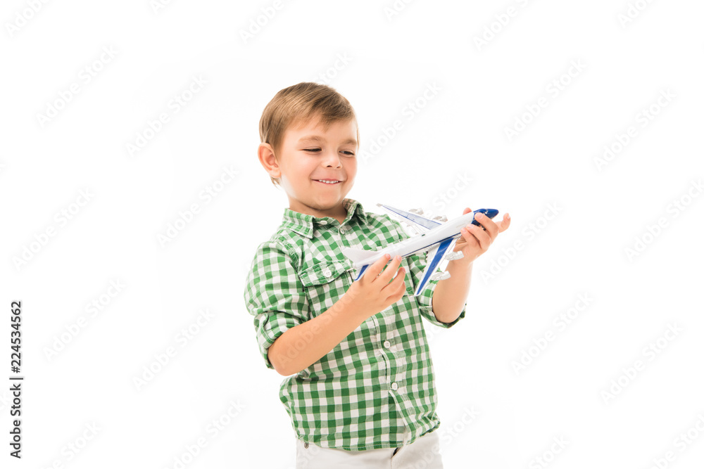 smiling little boy playing with toy plane isolated on white background smiling little boy playing with toy plane isolated on white background