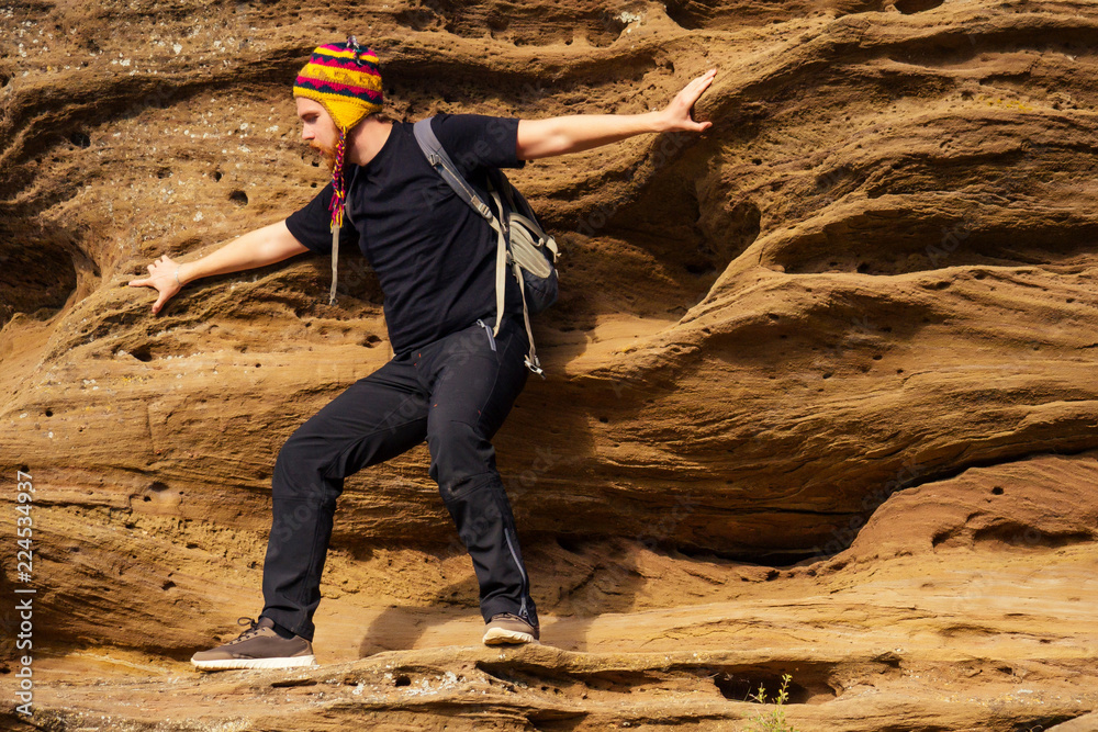 Man brave redhaired beard climbing bouldering stone rock tourist