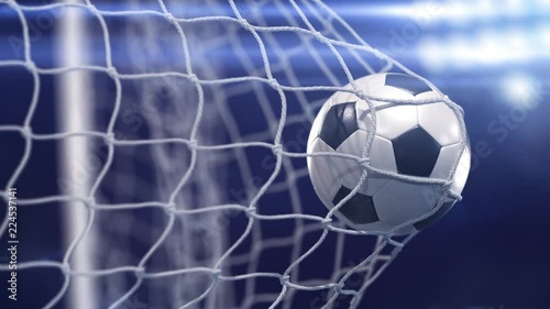 Beautiful soccer ball flies into net. Projector of light on a background. In slow motion