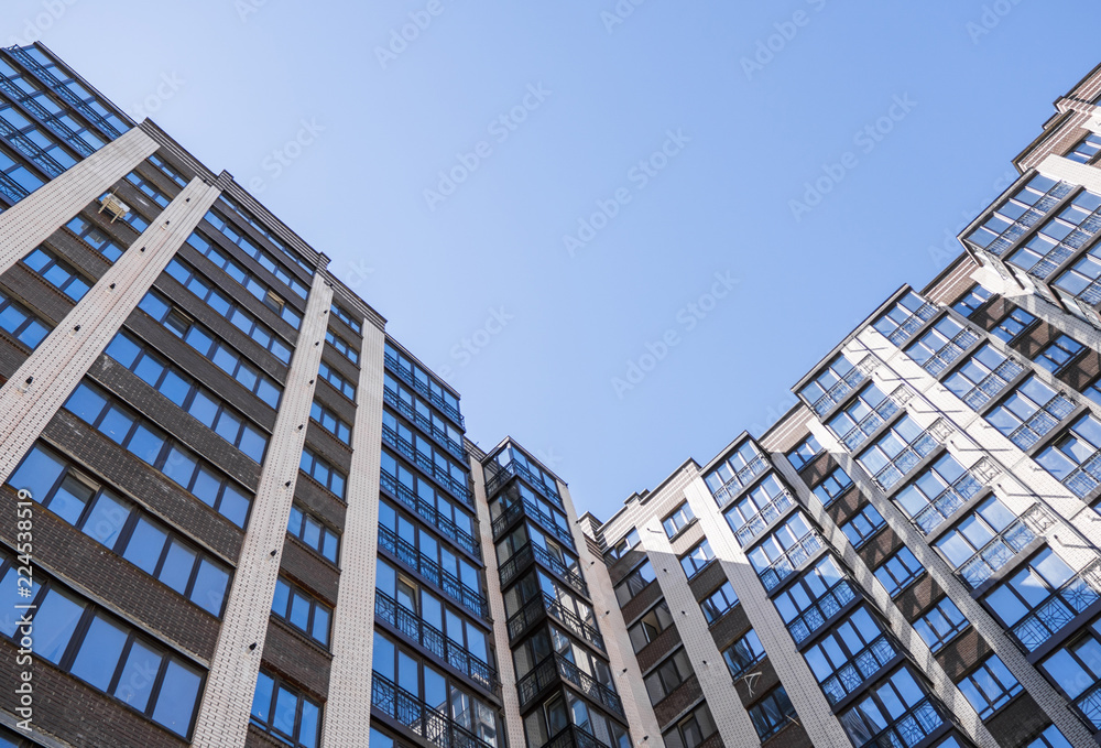 Fototapeta premium Modern and new apartment building. Multistoried, modern, new and stylish living block of flats. Real estate. New house. Newly built block of flats.