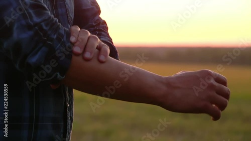 The farmer rolls up his sleeves