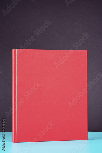 Red book on the green metal table.