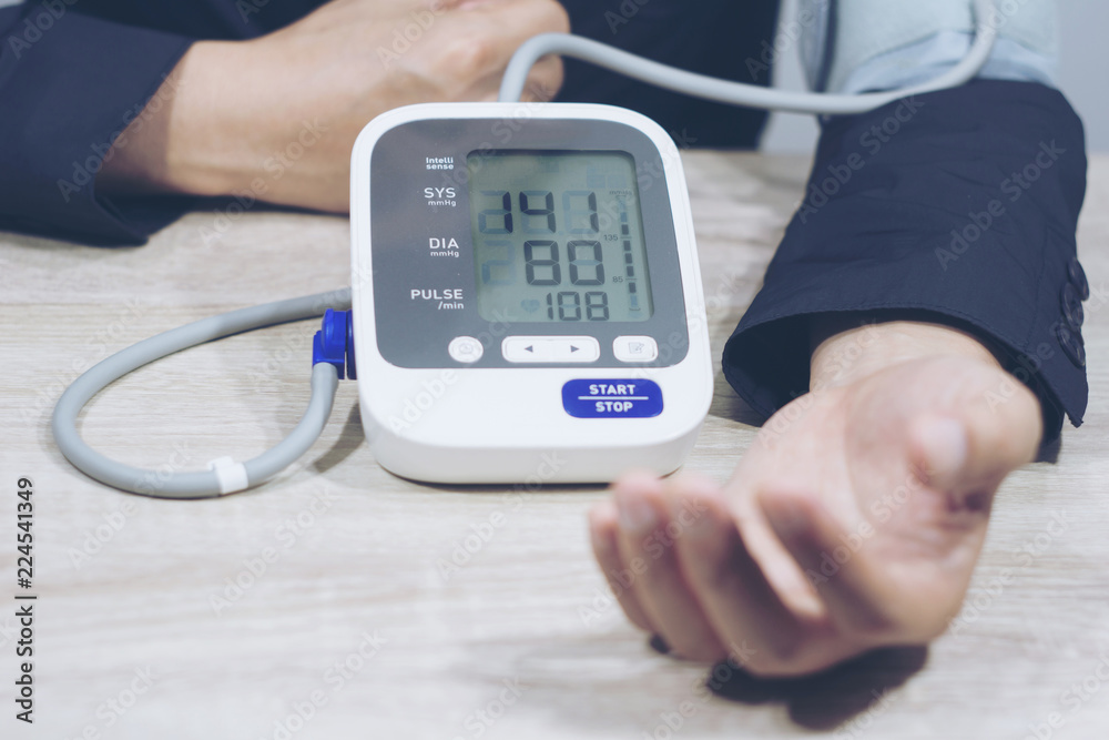 Man is taking care for health with hearth beat monitor and blood pressure. . Health concept Man is taking care for health with hearth beat monitor and blood pressure. . Health concept