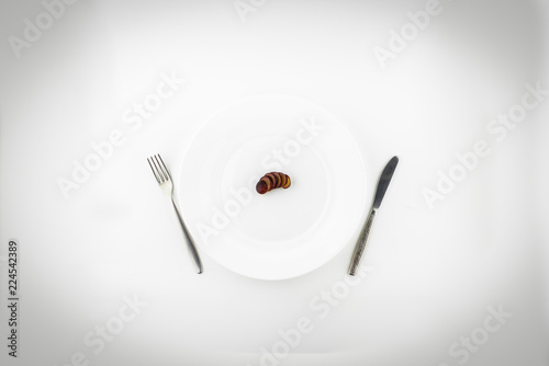 diet: strict diet - one grapes sliced on a white plate, top view, white background