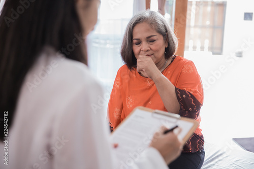 mature woman feeling unwell visitting doctor photo