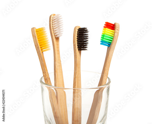 Set of toothbrushes in glass isolated on white background. Concept toothbrush selection, bamboo eco-friendly. Concept of sexual minorities and LGBT community