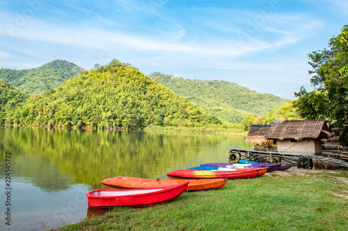 The wooden raft and Kayak in the water reservoirs and mountain views.