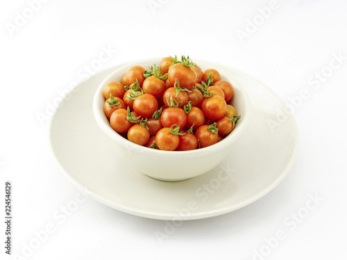 Fresh cherry tomatoes in bowl isolated on white background